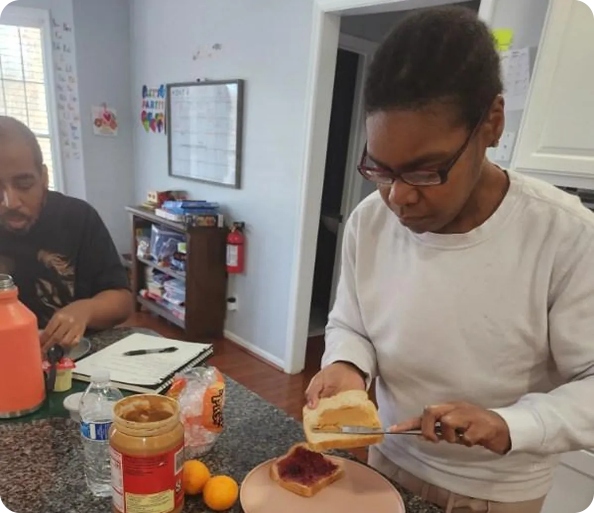 Woman making a peanut butter sandwich.