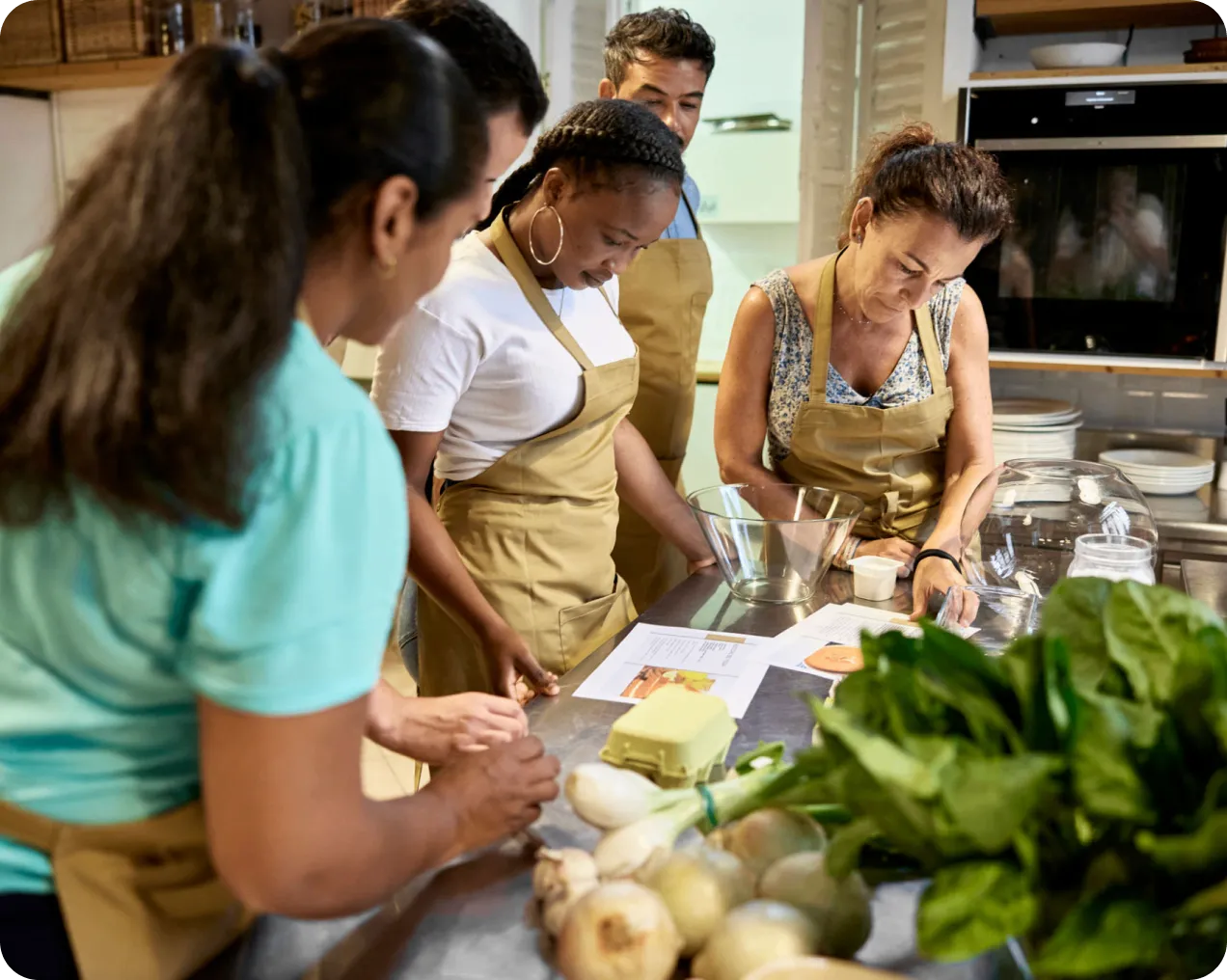 People cooking together in a kitchen class.