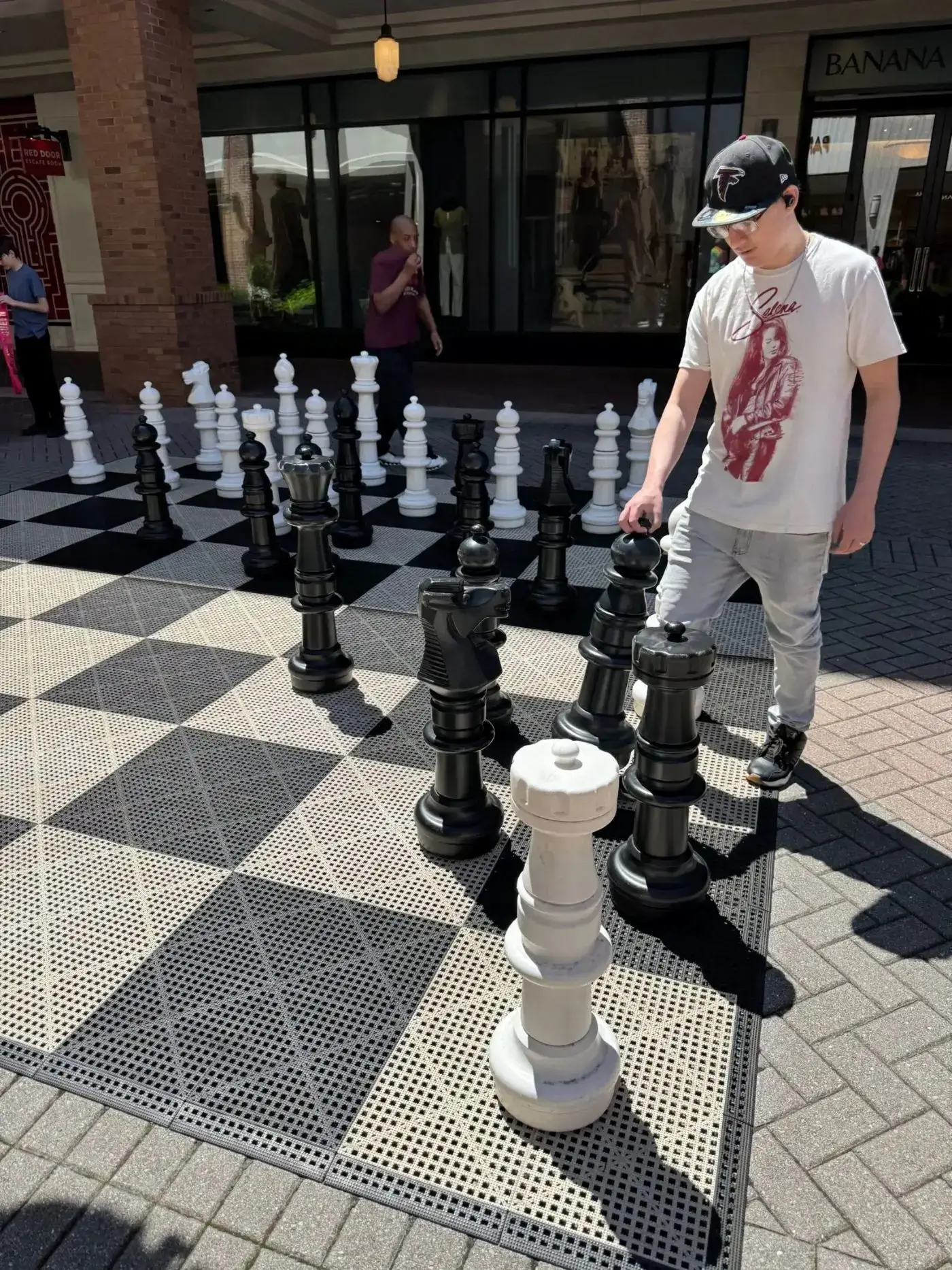 Person moving giant outdoor chess piece