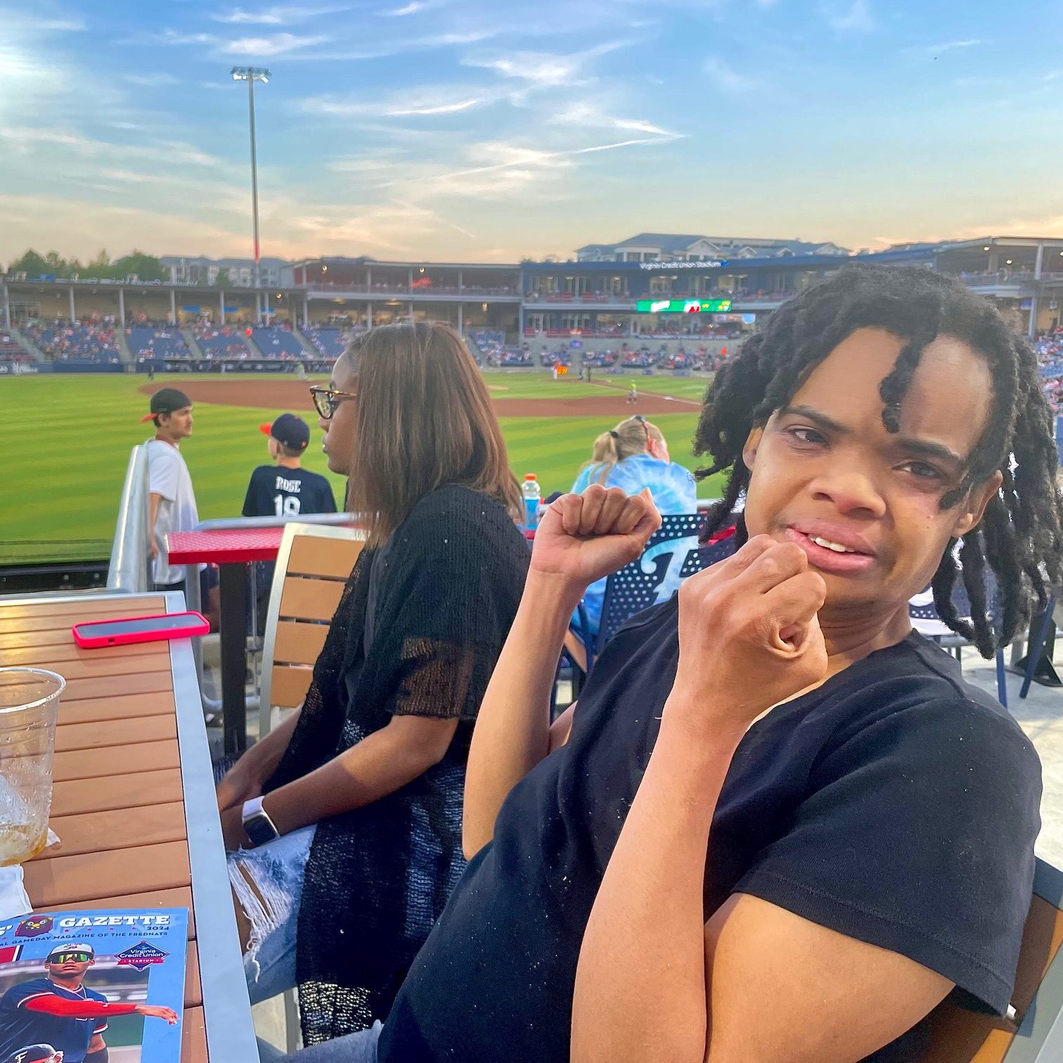 Happy young man enjoying a sunny day at a sports stadium.