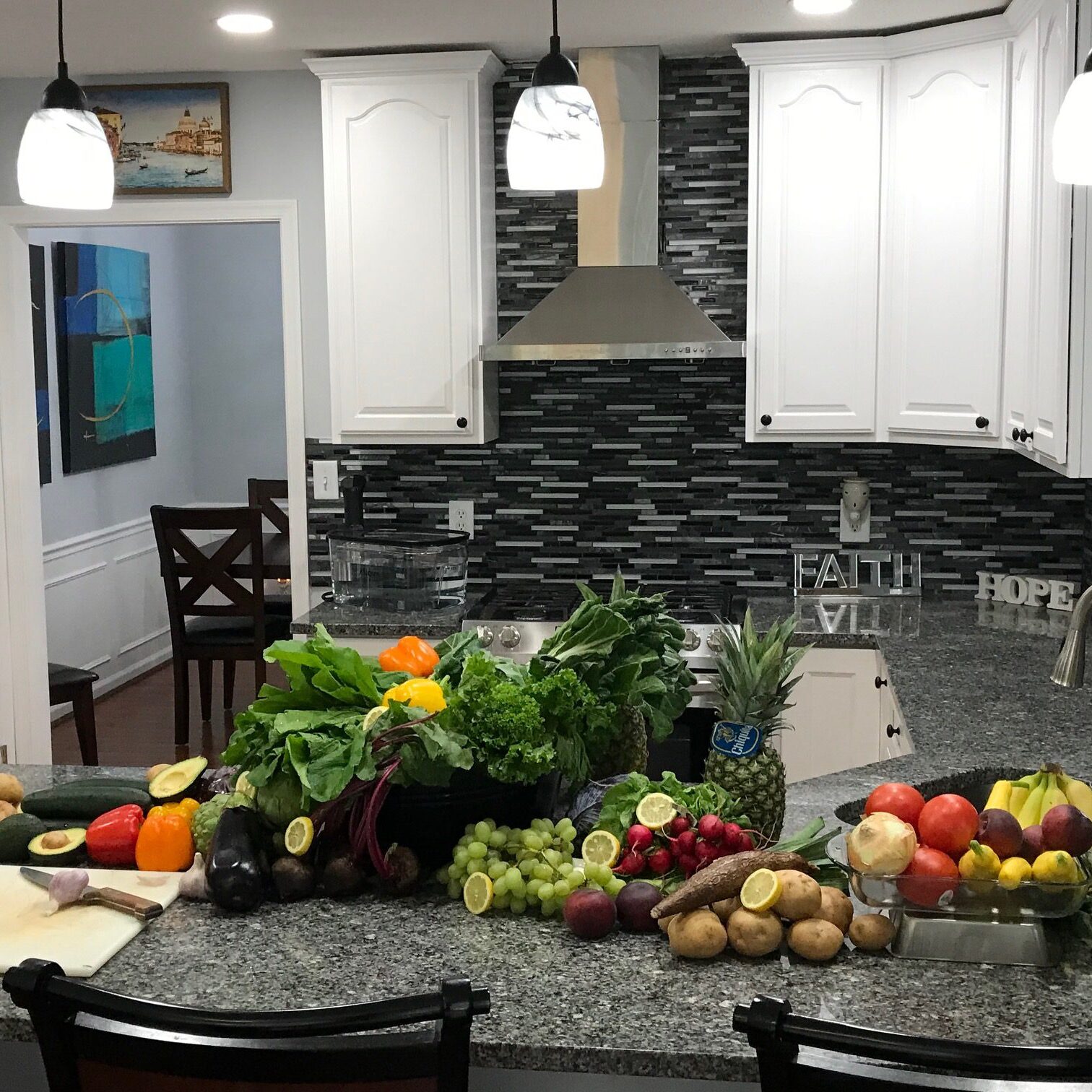 Kitchen counter with assorted fruits and vegetables.