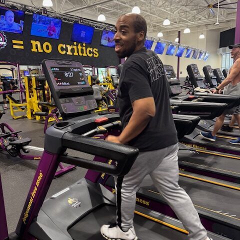 Man walking on treadmill at the gym.
